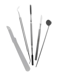 Photo of Set of different dentist's tools on white background, top view