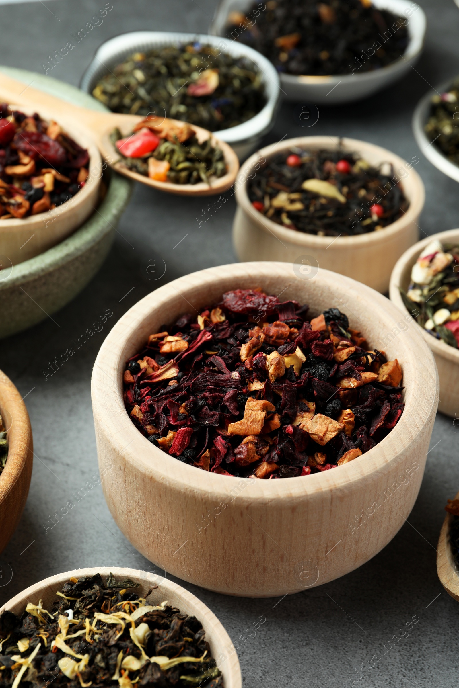 Photo of Many different herbal teas on grey table