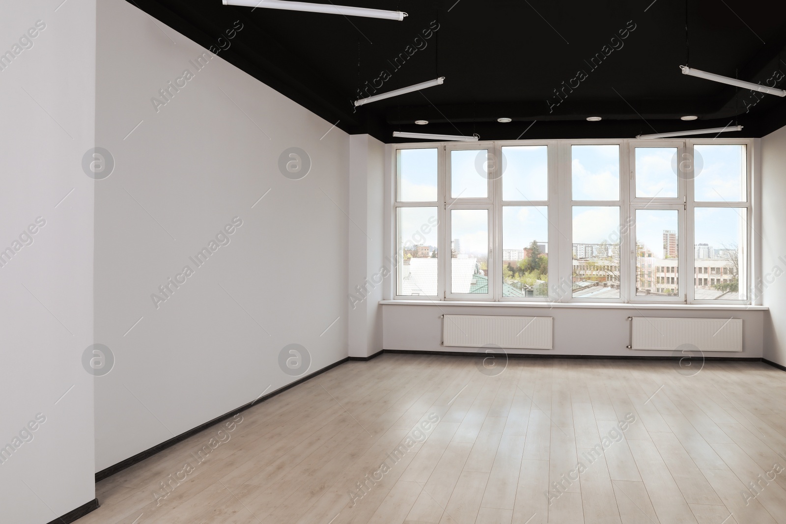 Photo of Modern office with window and radiators. Interior design