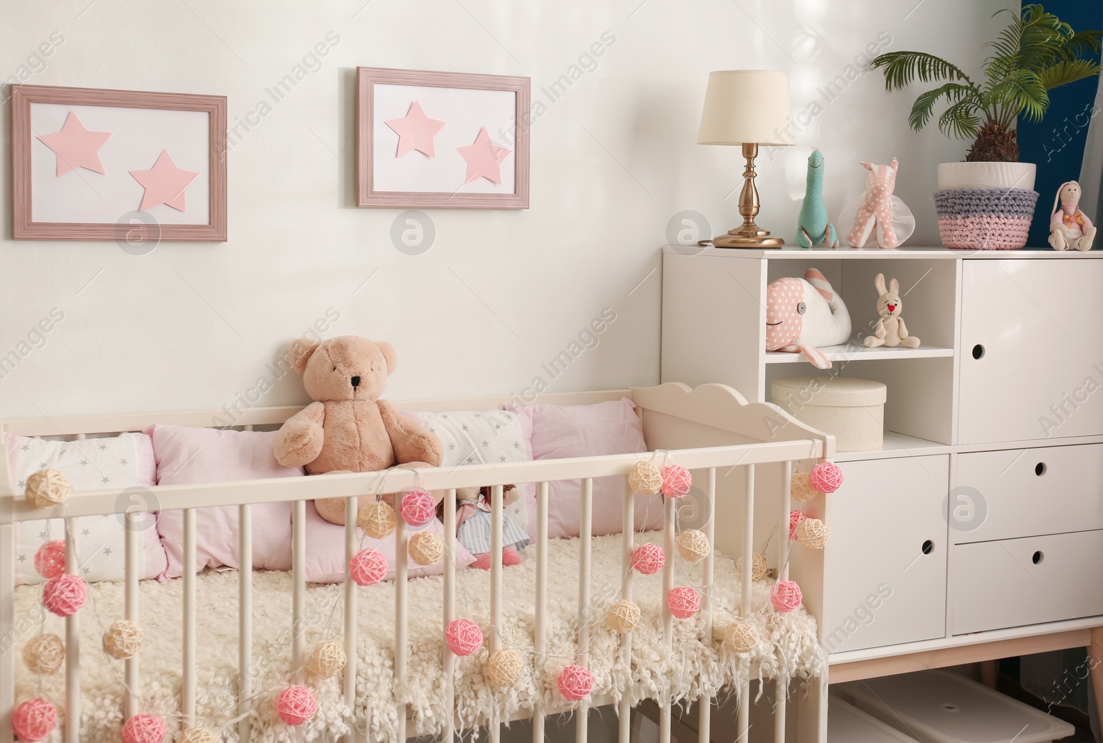 Photo of Cozy baby room interior with comfortable crib