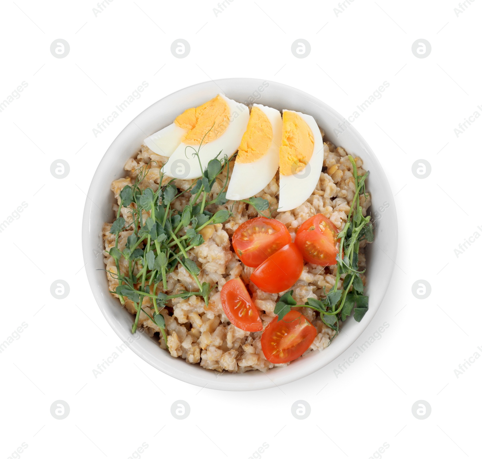 Photo of Tasty boiled oatmeal with egg and tomatoes isolated on white, top view