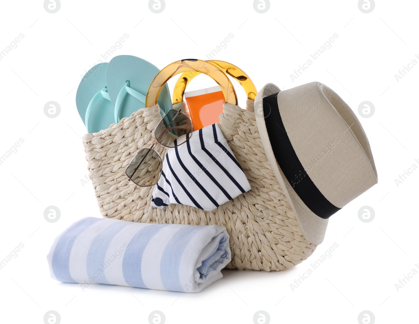 Photo of Bag with different beach objects and towel on white background
