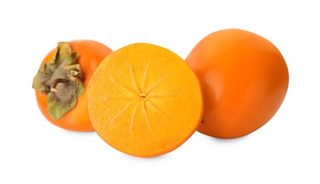 Whole and cut delicious ripe juicy persimmons on white background