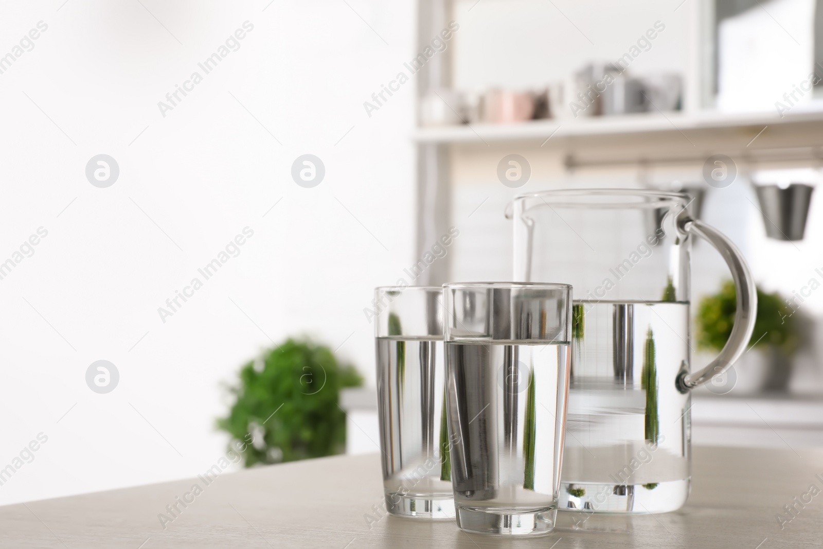 Photo of Glassware of fresh water on table indoors. Space for text