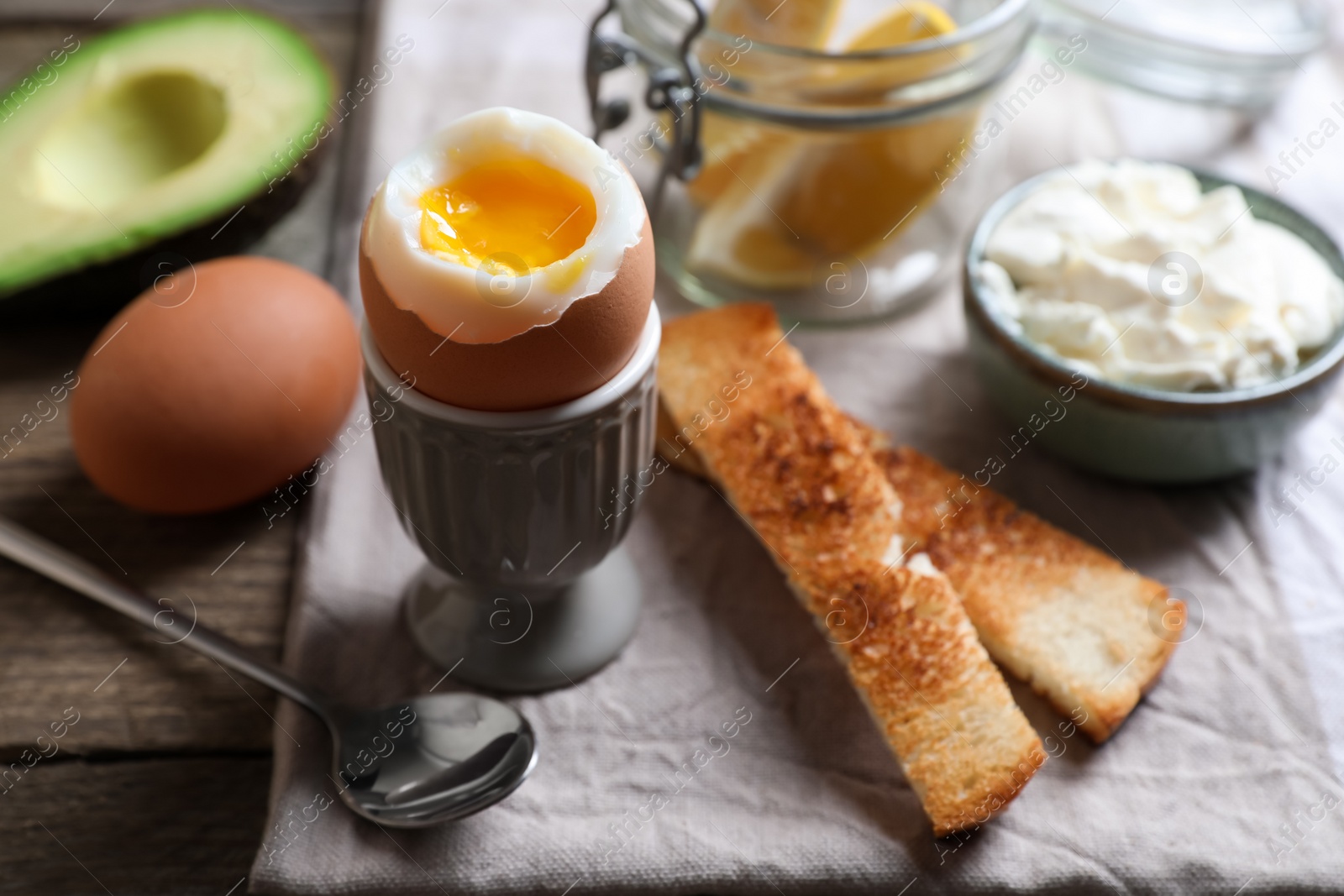 Photo of Soft boiled egg served for breakfast on wooden table