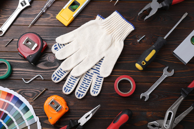 Flat lay composition with different construction tools on wooden background