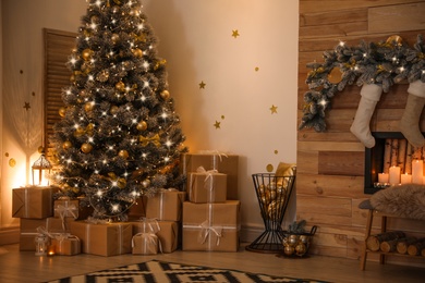 Stylish room interior with beautiful Christmas tree and gift boxes