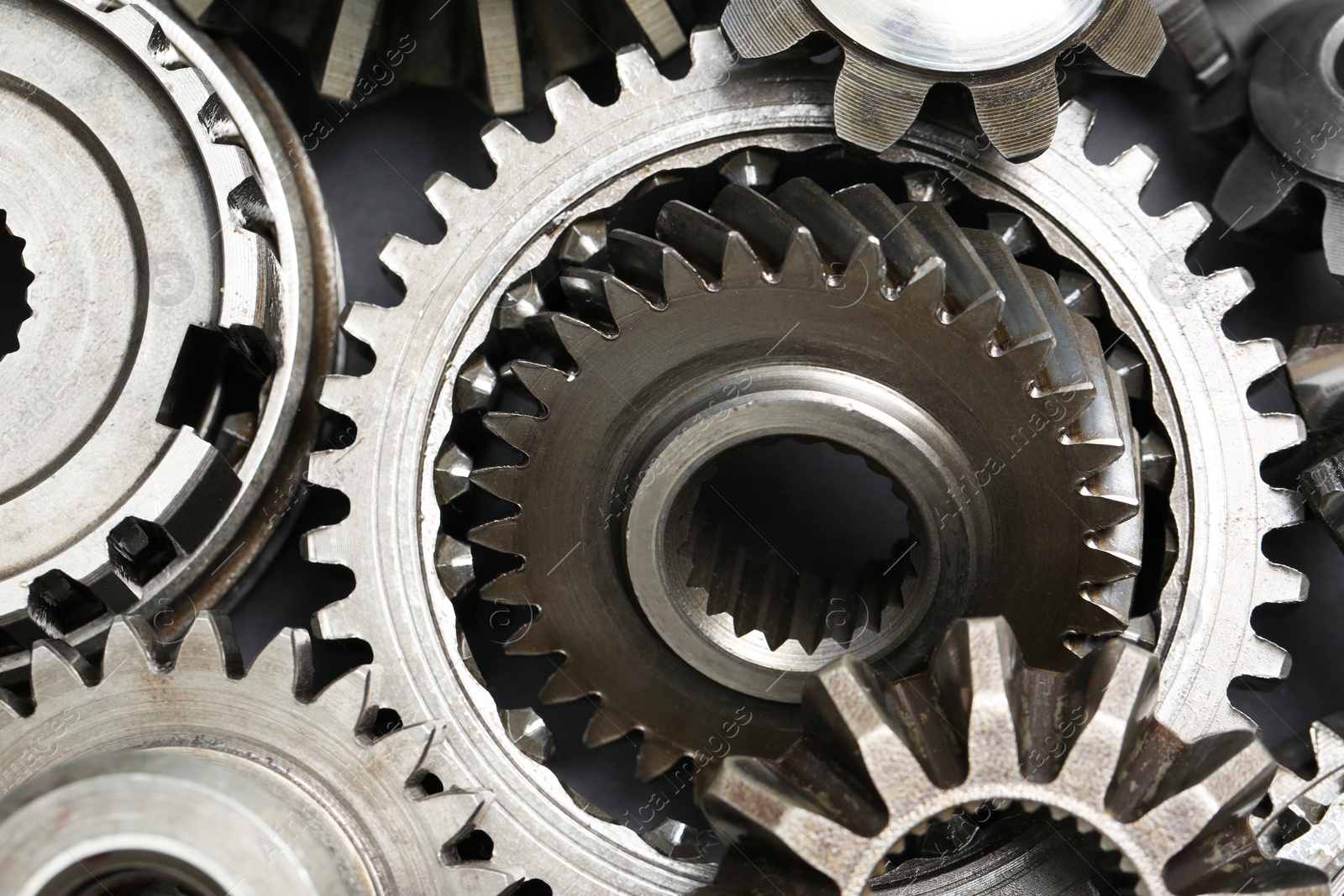 Photo of Many different stainless steel gears as background, top view