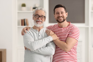 Photo of Happy son and his dad at home