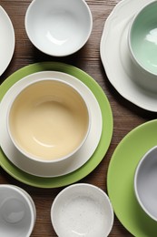 Photo of Beautiful ceramic dishware on wooden table, flat lay