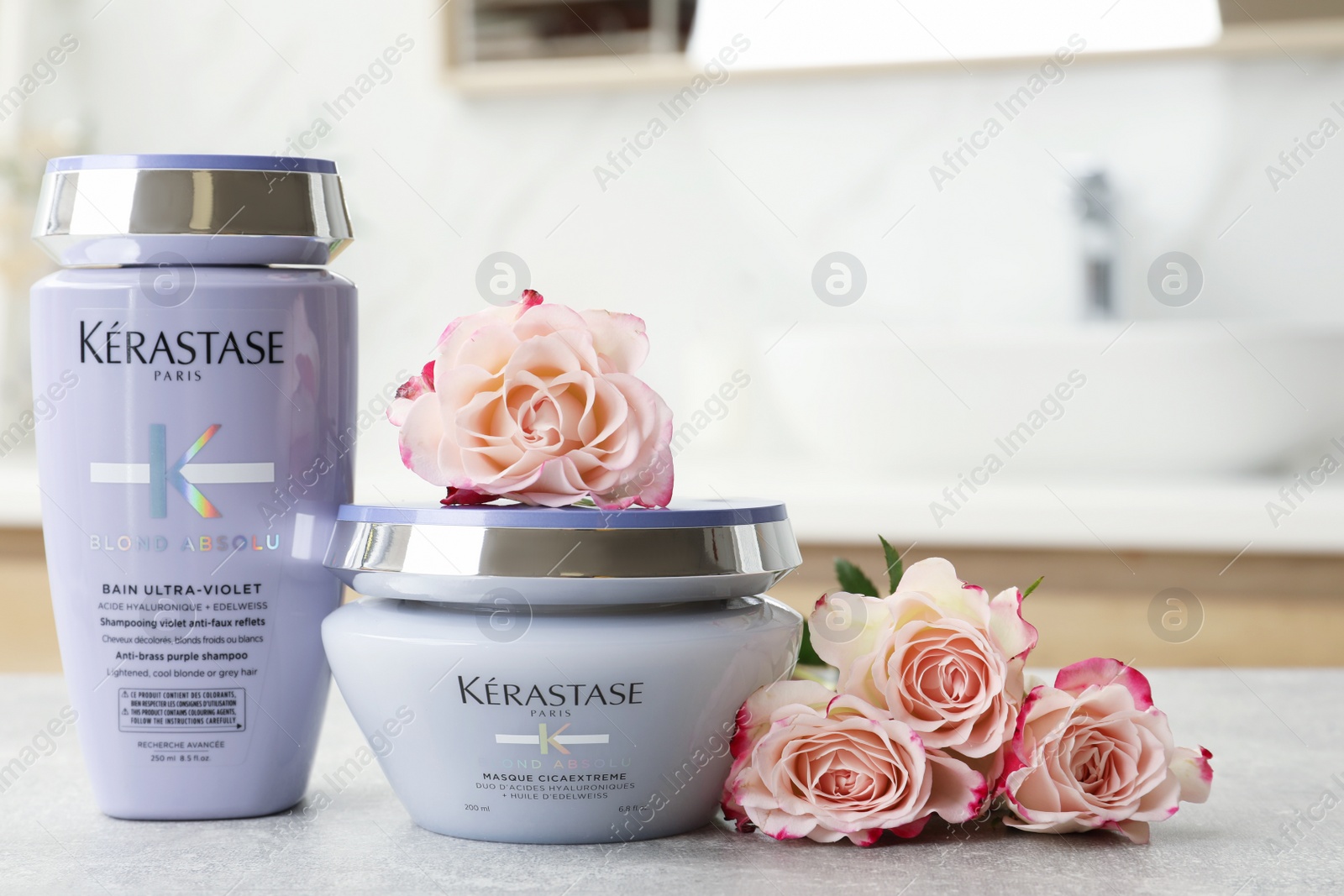 Photo of MYKOLAIV, UKRAINE - SEPTEMBER 07, 2021: Kerastase hair care cosmetic products on light table in bathroom. Space for text