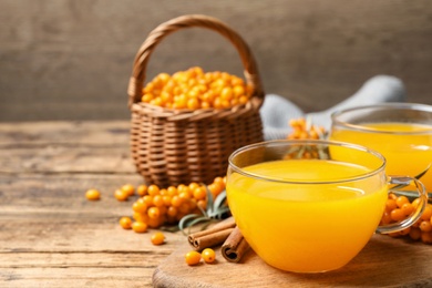 Fresh sea buckthorn tea on wooden table