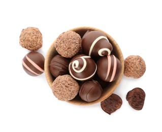 Photo of Bowl with many different delicious chocolate truffles on white background, top view