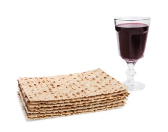 Traditional matzos and red wine on white background