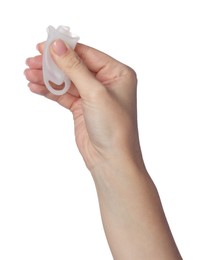 Photo of Woman folding menstrual cup on white background, closeup