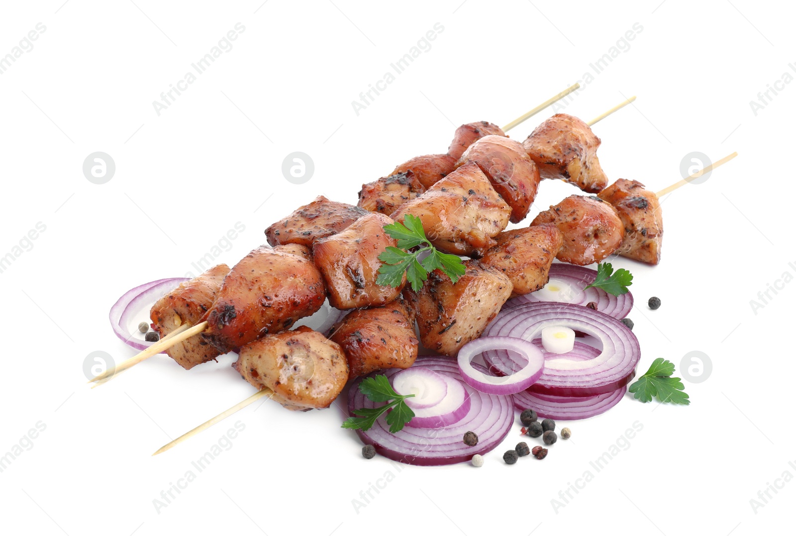 Photo of Delicious shish kebabs with onion, parsley and spices isolated on white