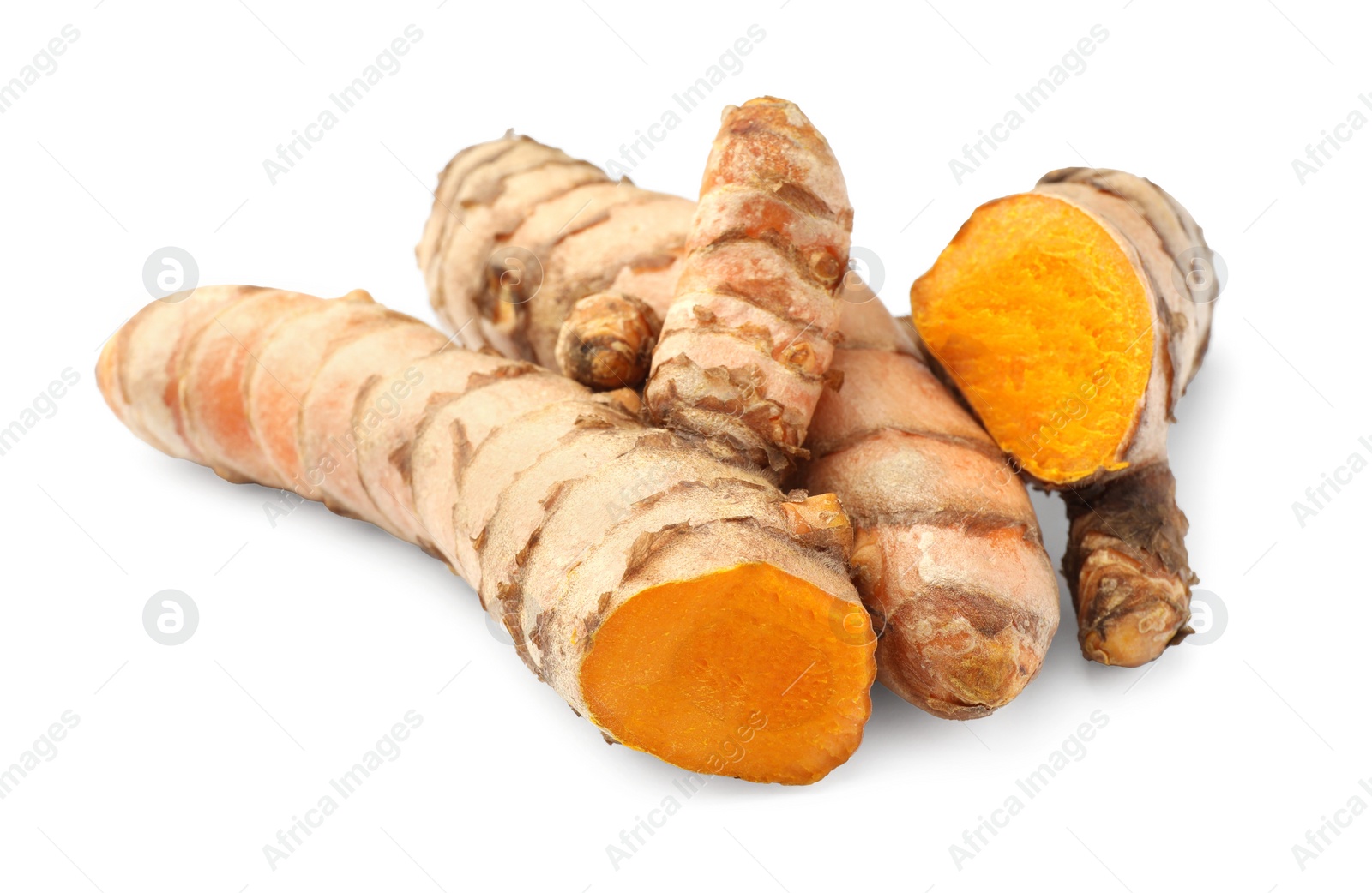 Photo of Whole and cut turmeric roots isolated on white