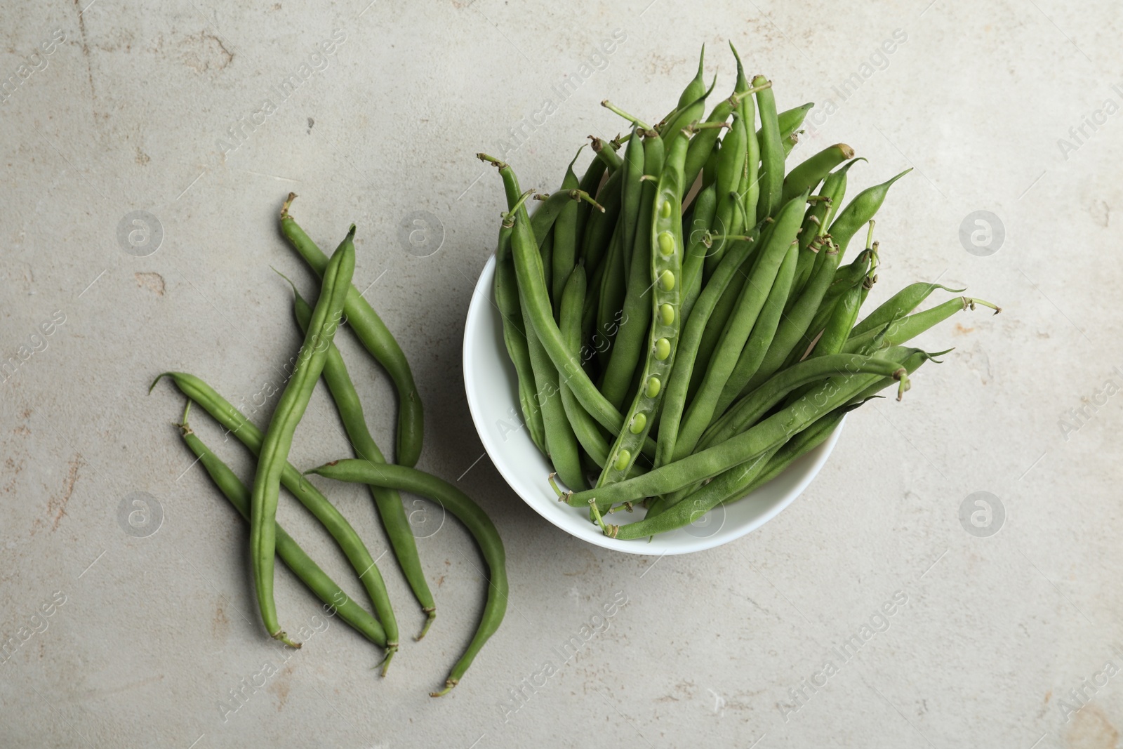 Photo of Fresh green beans on light grey table, flat lay