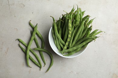 Photo of Fresh green beans on light grey table, flat lay