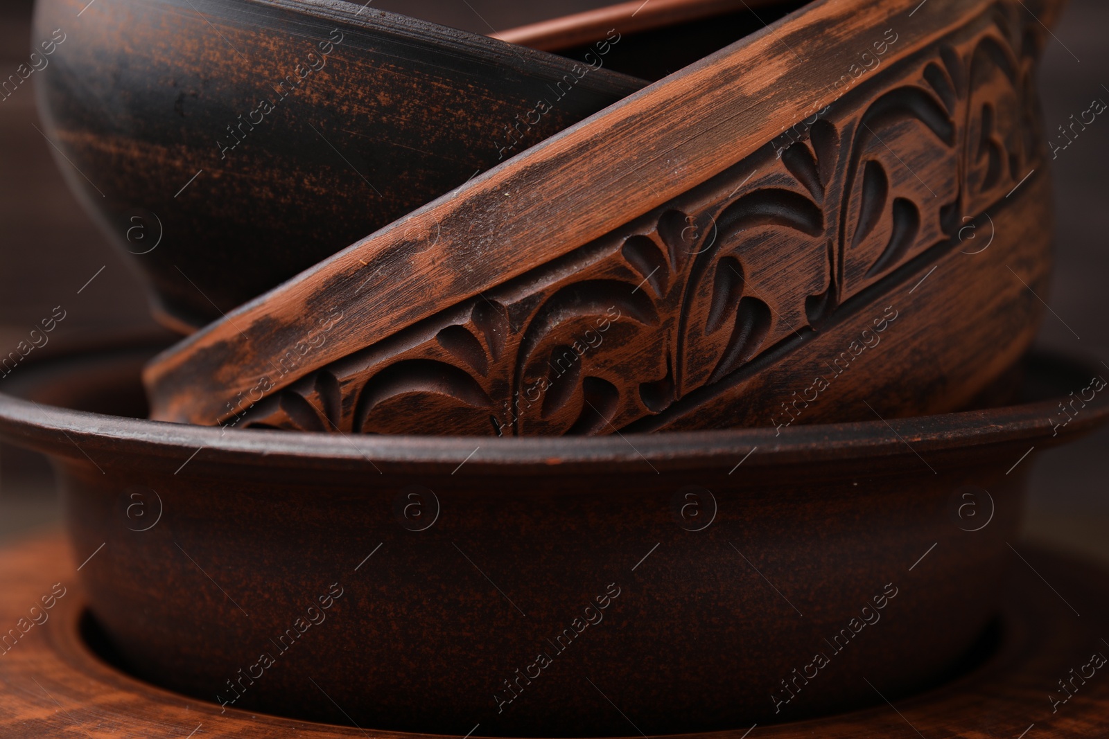 Photo of Set of clay dishes, closeup. Cooking utensils