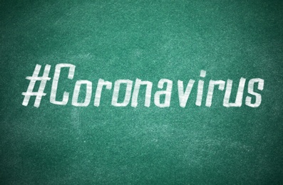 Hashtag Coronavirus written with white chalk on greenboard