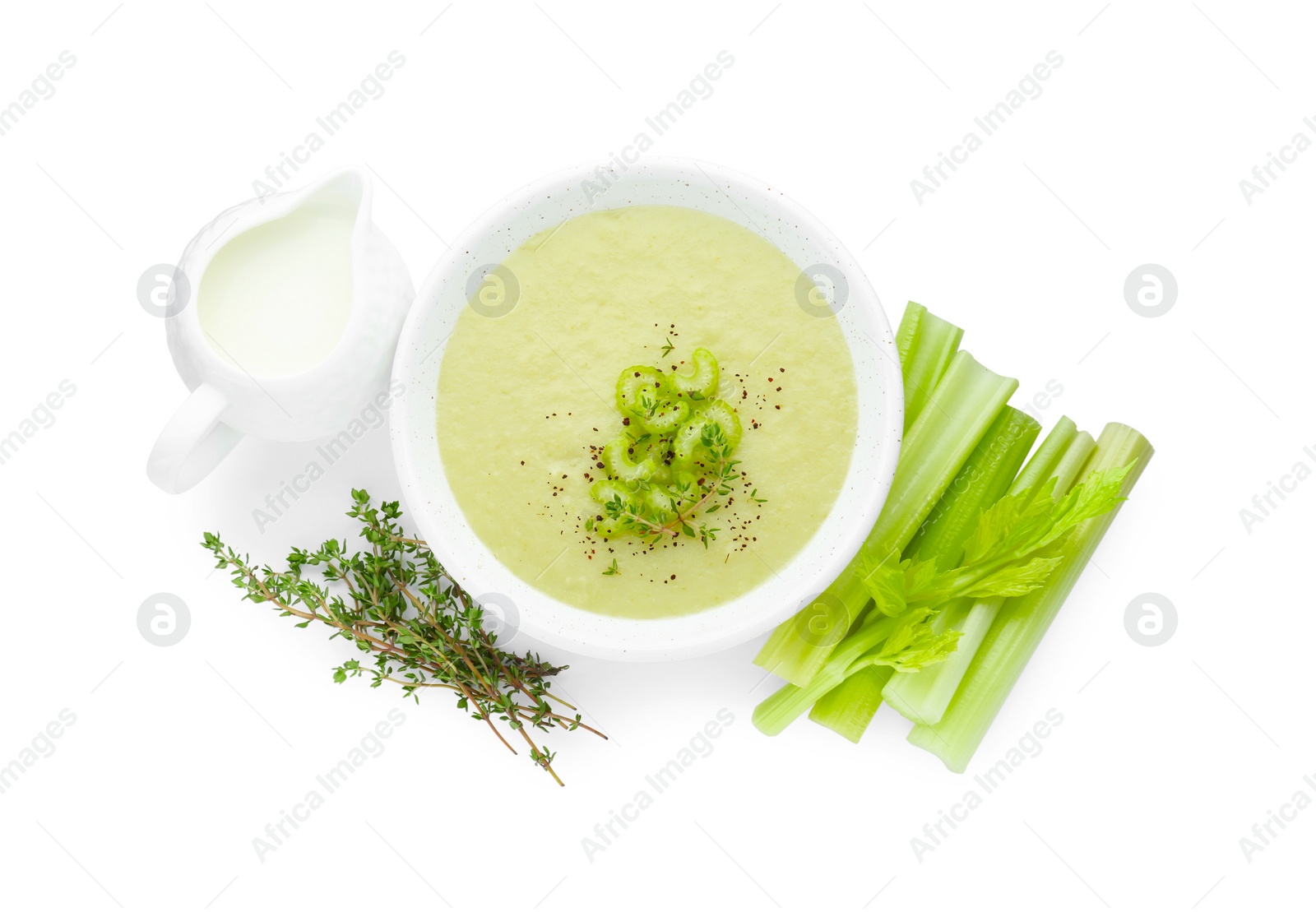 Photo of Bowl of delicious celery soup and ingredients isolated on white, top view