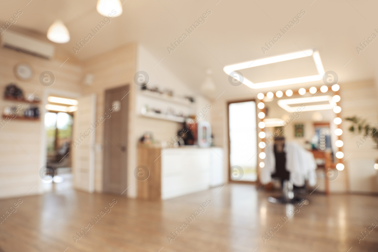 Photo of Blurred view of stylish barbershop interior with professional hairdresser's workplace