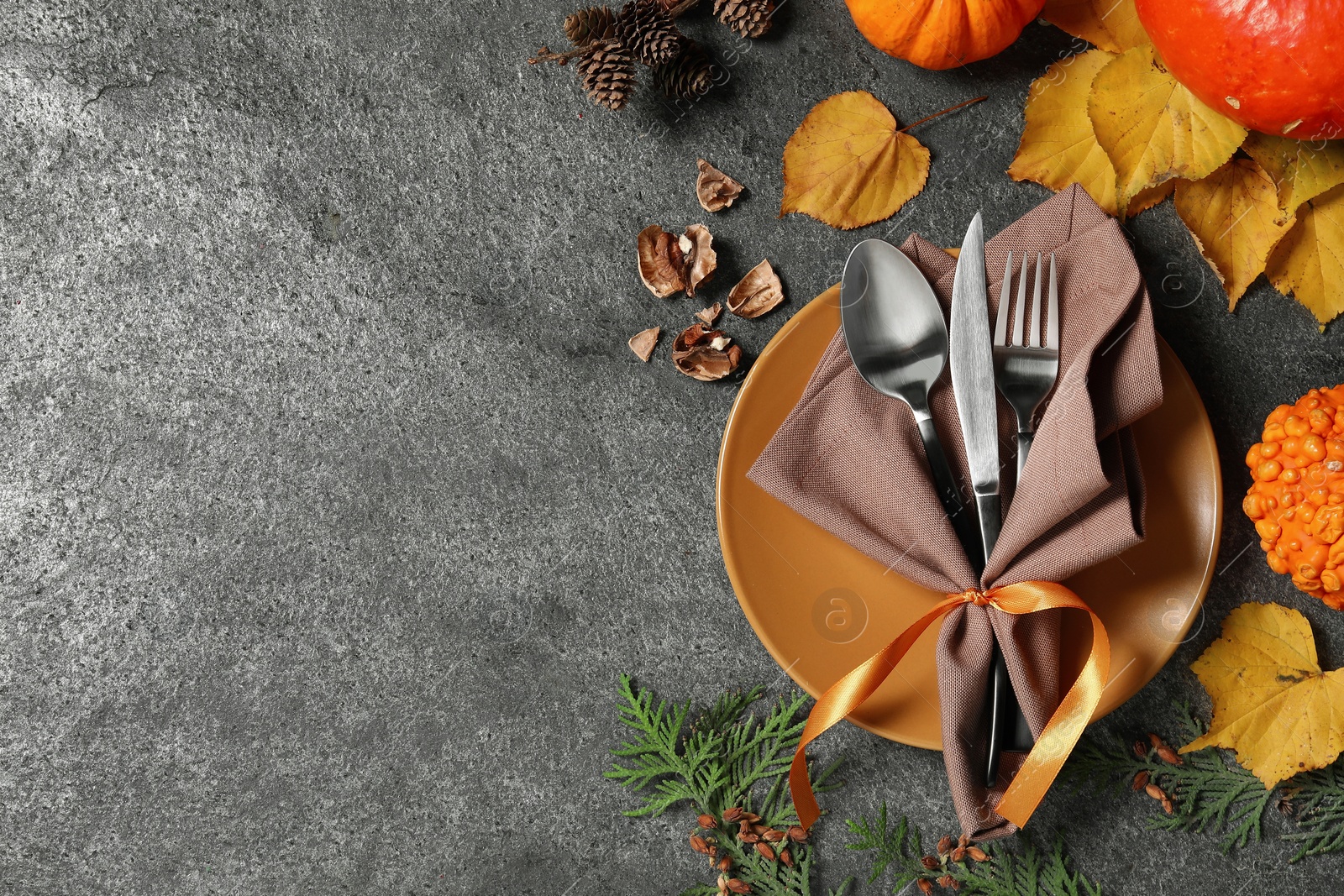 Photo of Happy Thanksgiving day. Beautiful table setting and autumn decoration on grey background, flat lay with space for text