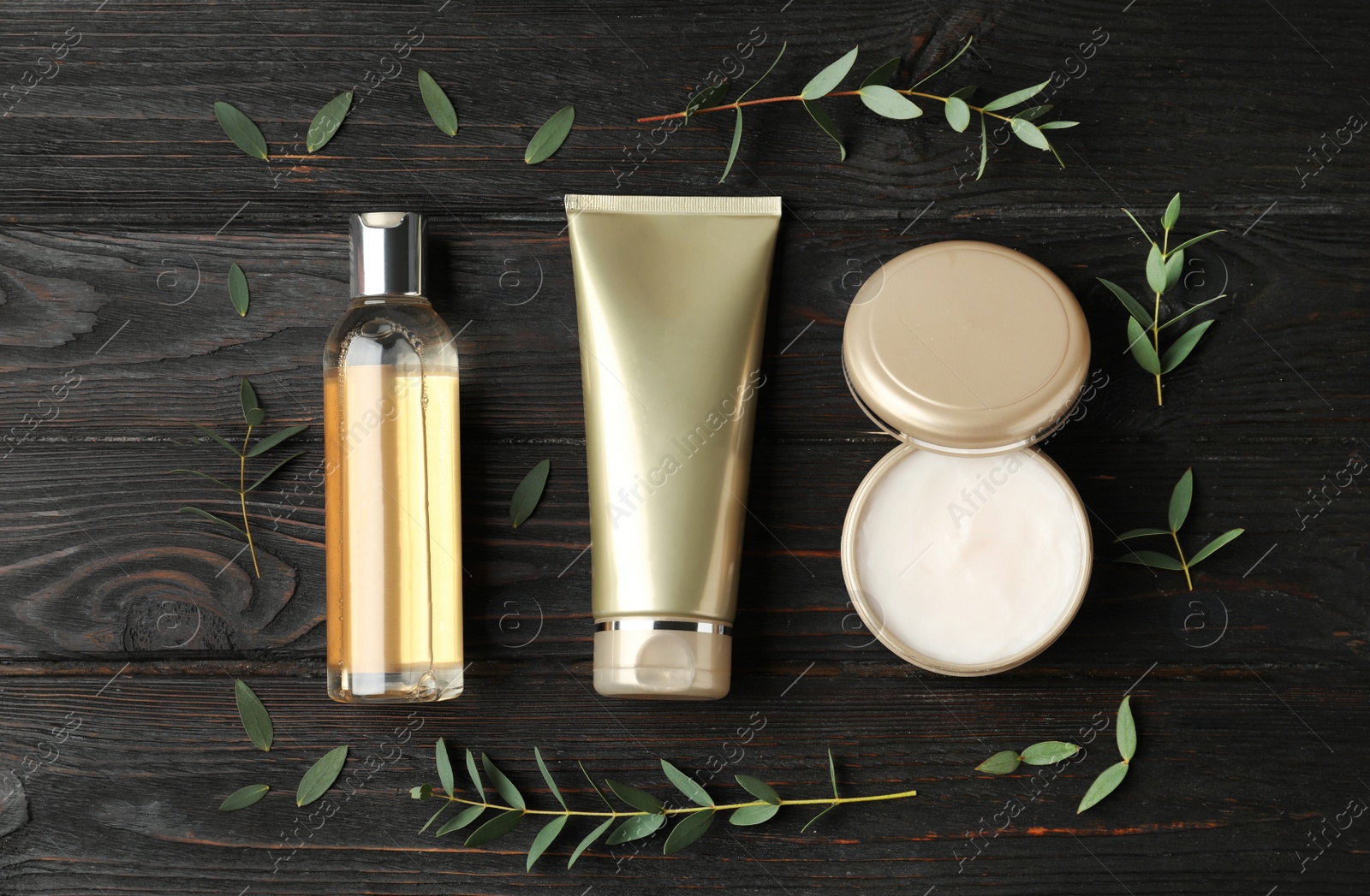 Photo of Flat lay composition with cosmetic products on black wooden table