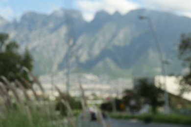 Photo of Road near city and big mountains, blurred view