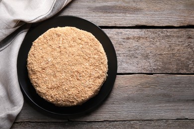 Delicious Napoleon cake on wooden table, top view. Space for text