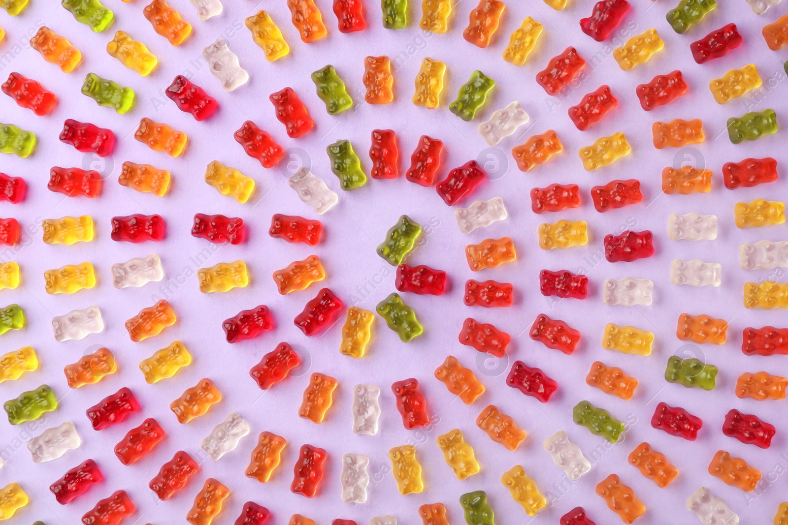 Photo of Flat lay composition with delicious jelly bears on color background