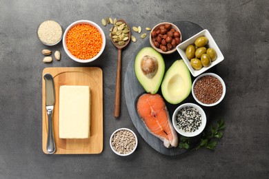 Different products high in natural fats on grey table, flat lay