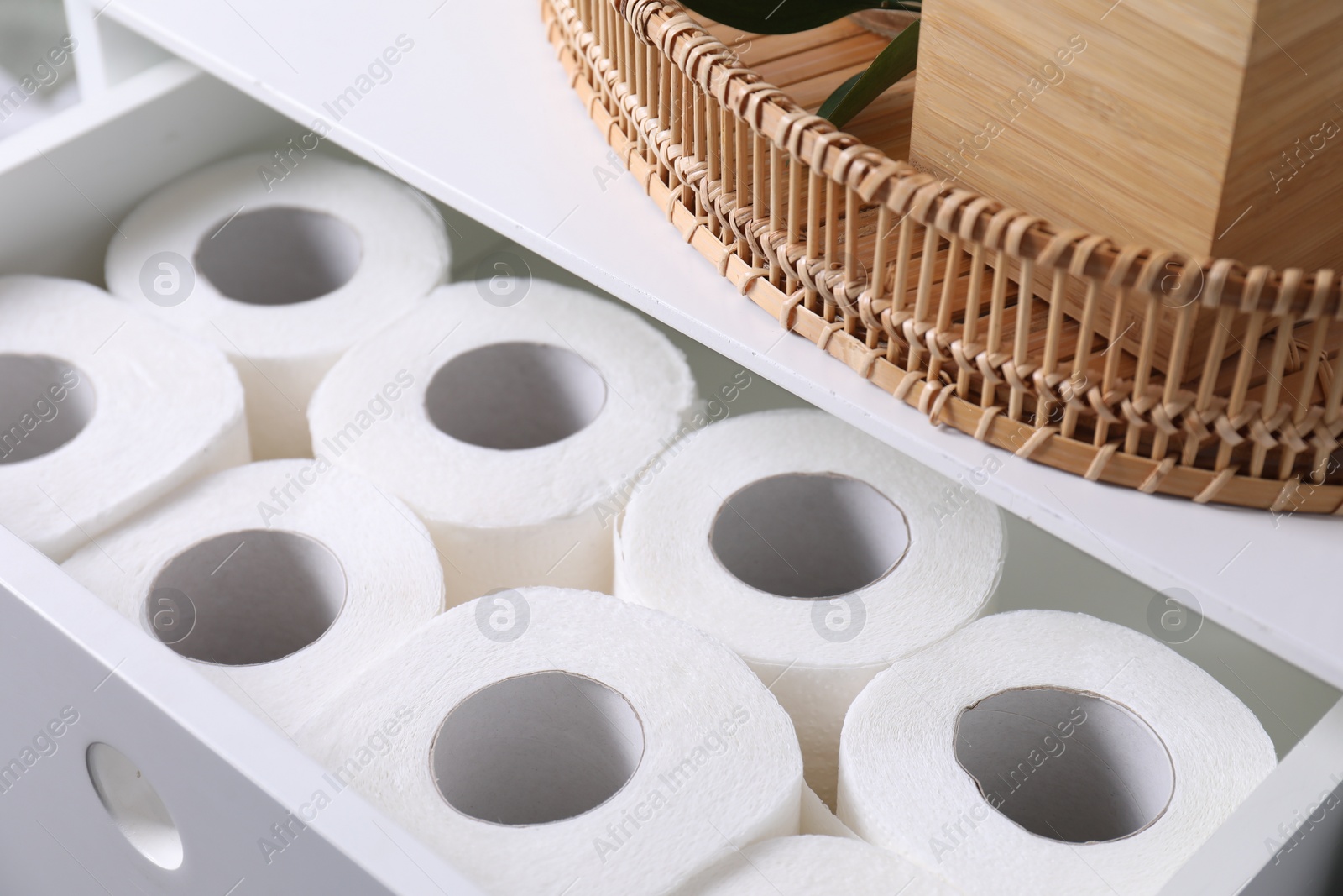 Photo of Many toilet paper rolls in white drawer indoors