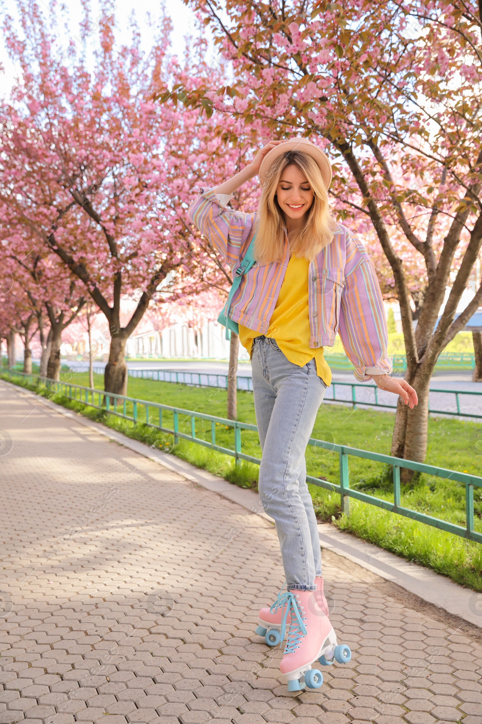 Photo of Young woman roller skating in spring park