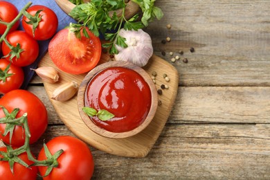 Photo of Tasty ketchup, fresh tomatoes, parsley and spices on wooden table, flat lay. Space for text