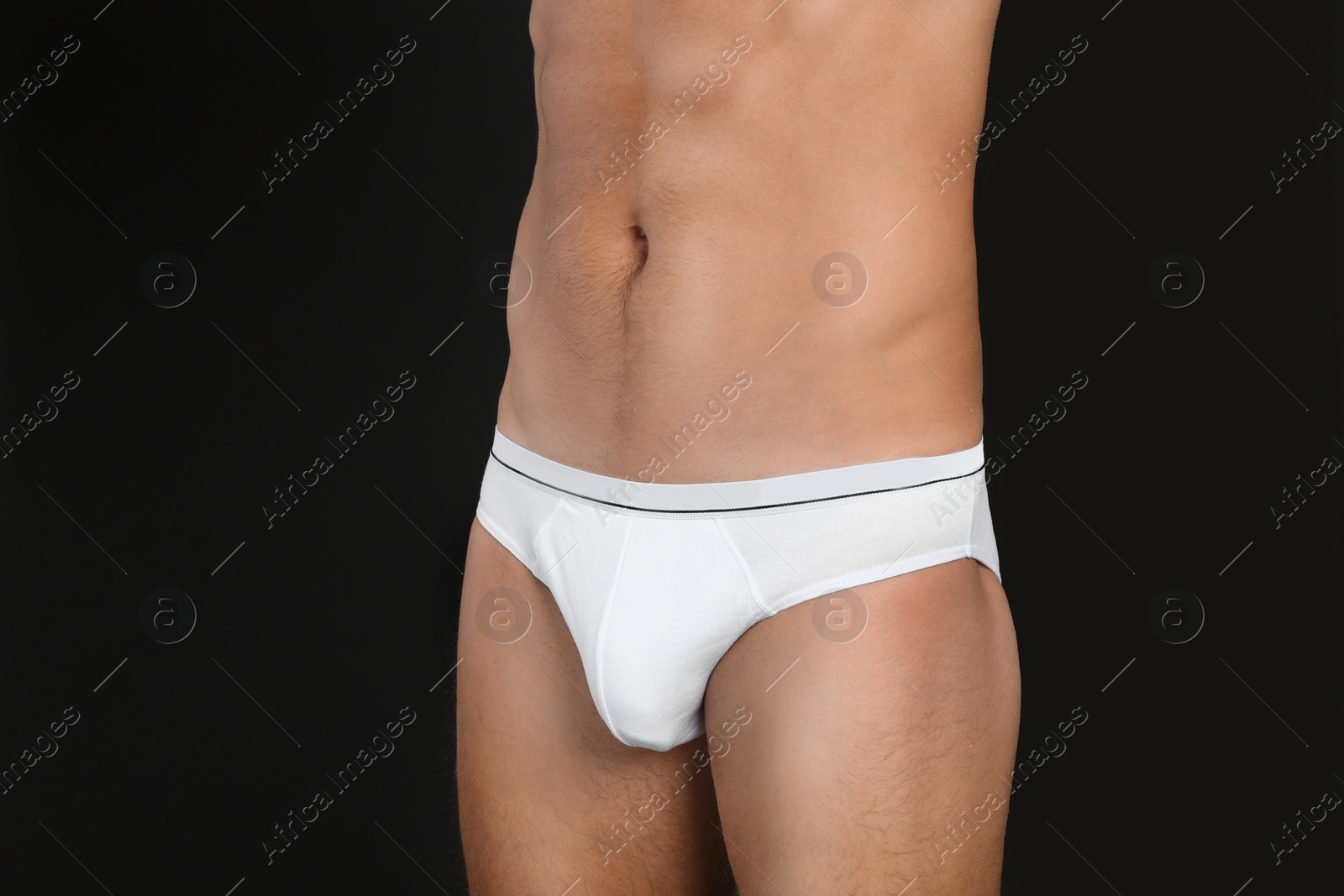 Photo of Man in underwear on black background, closeup