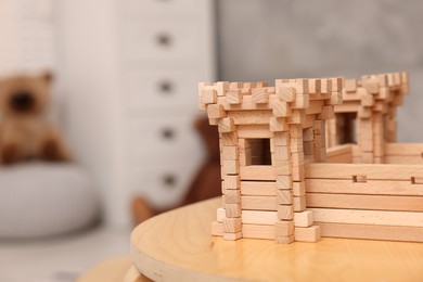 Wooden fortress on table indoors, space for text. Children's toy