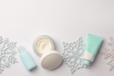 Photo of Winter skin care. Flat lay composition with hand cream and cosmetic products on white background. Space for text