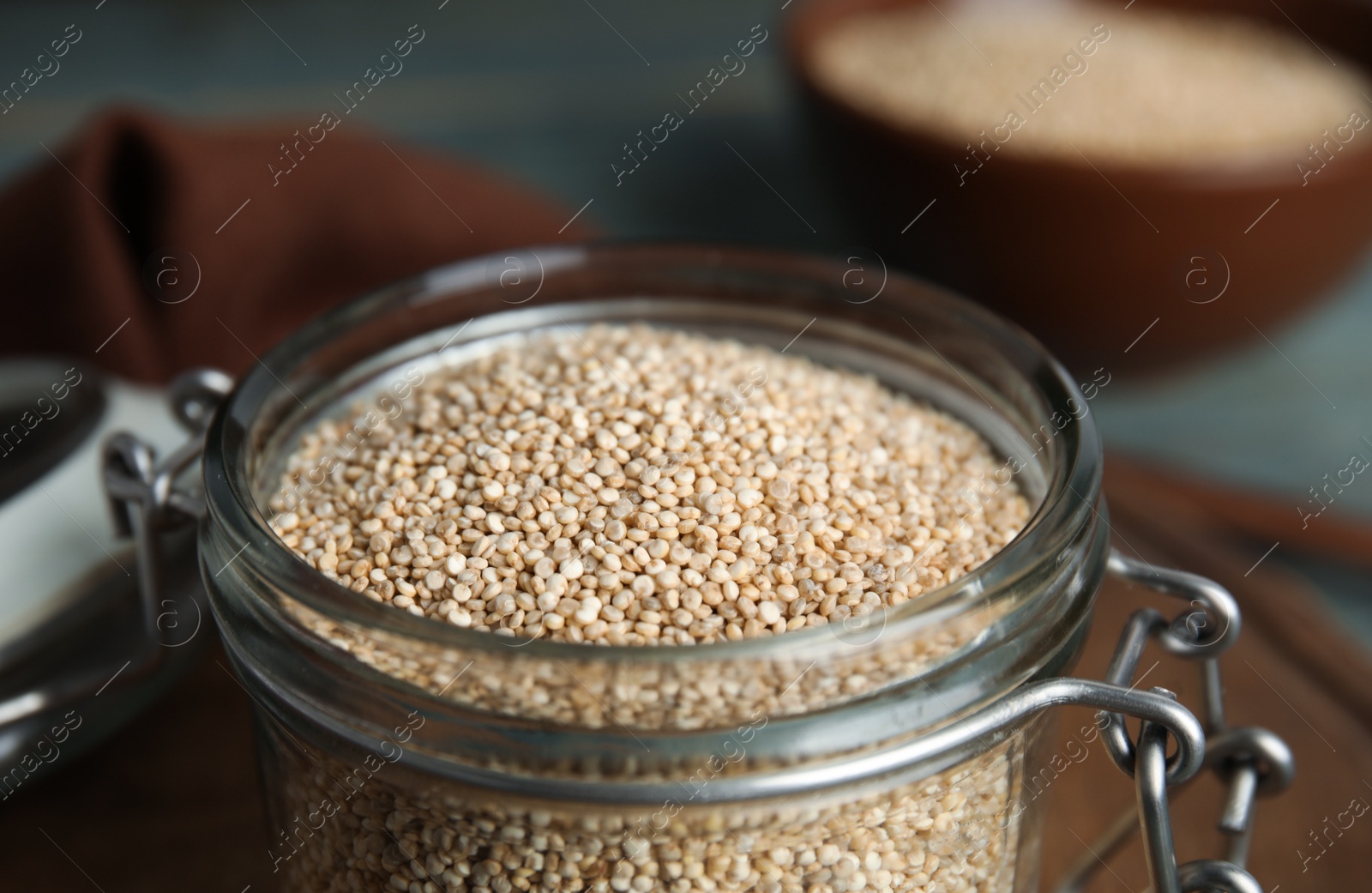 Photo of Glass jar with white quinoa on table, closeup