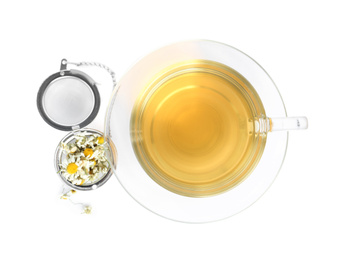 Photo of Fresh chamomile tea and dry flowers in infuser isolated on white, top view