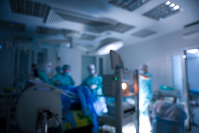Blurred view of medical team performing surgery in operating room
