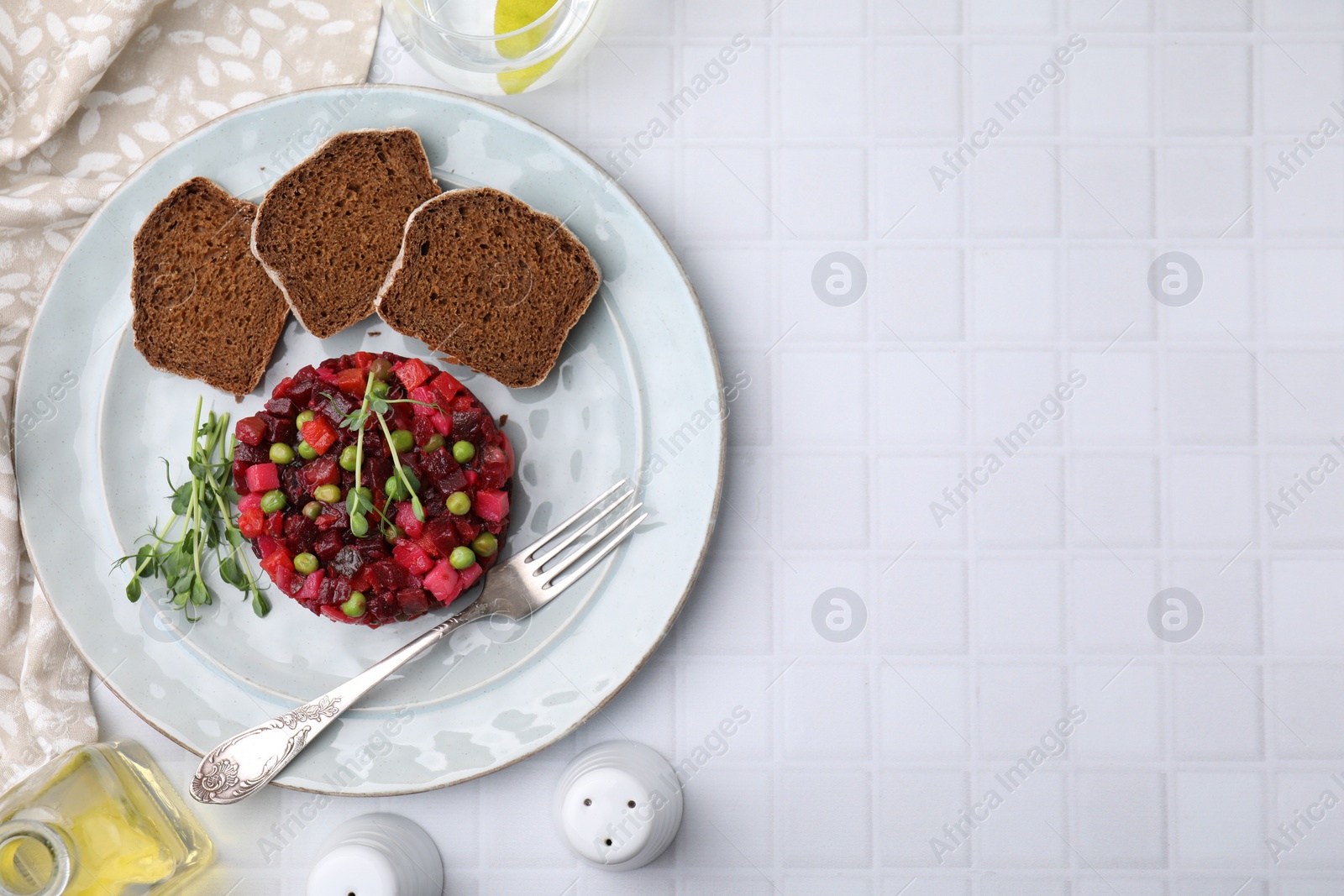 Photo of Delicious vinaigrette salad with slices of bread on white table, flat lay. Space for text