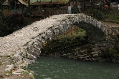 Photo of Adjara, Georgia - November 19, 2022: Picturesque view of stone arched bridge over Acharistskali river