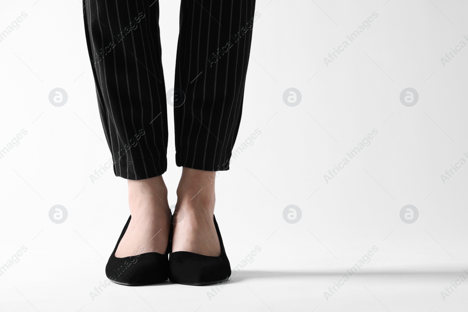 Photo of Businesswoman in black shoes on white background, closeup