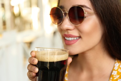 Beautiful woman with cold kvass outdoors, closeup. Traditional Russian summer drink