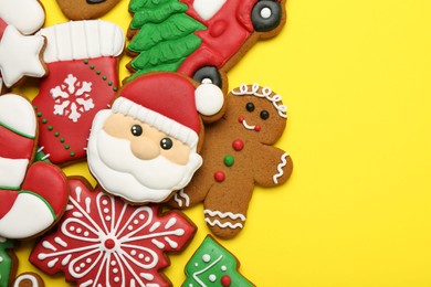 Photo of Different tasty Christmas cookies on yellow background, flat lay. Space for text