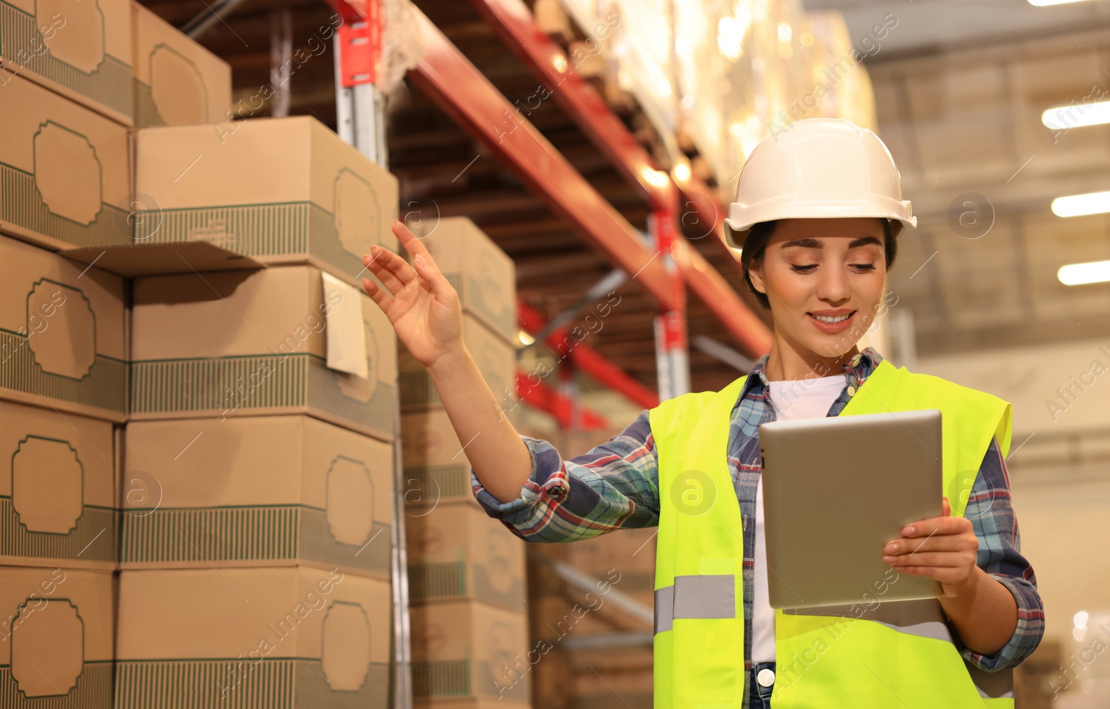 Image of Woman with tablet working at warehouse. Logistics center