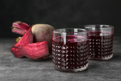 Glasses with fresh healthy beet juice on table