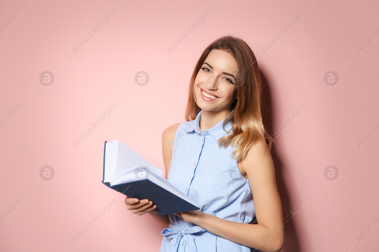 Photo of Young woman with book on color background, space for text